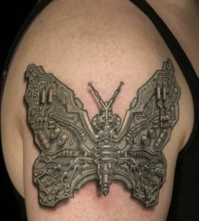 Schemes and butterfly tattoo on shoulder