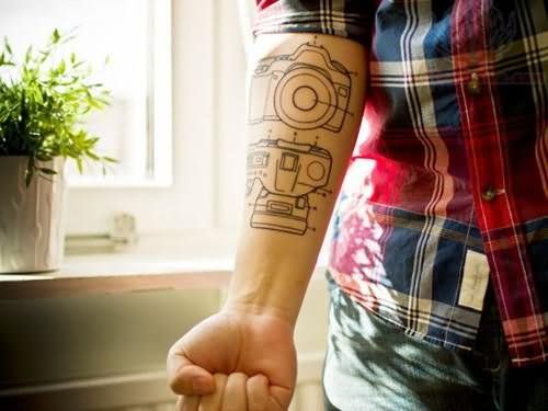 Schemes of black camera tattoo on arm