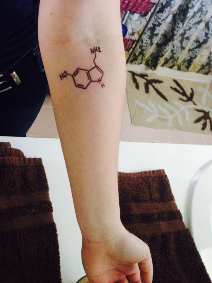 Serotonin tattoo on left arm