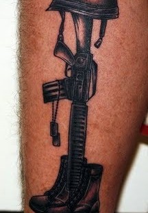 Shoes, helmet and gun soldier tattoo on arm