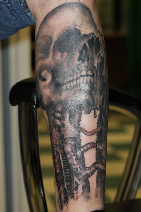 Simple black skull tattoo on leg