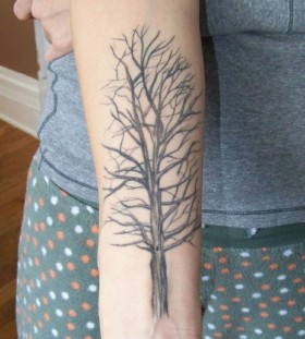 Simple black tree tattoo on arm