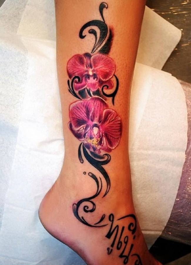 Simple pink flower tattoo on leg