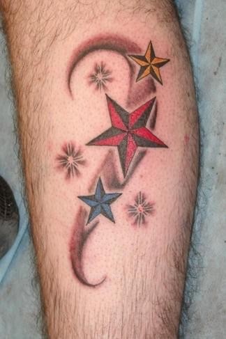 Simple red green blue star tattoo on leg