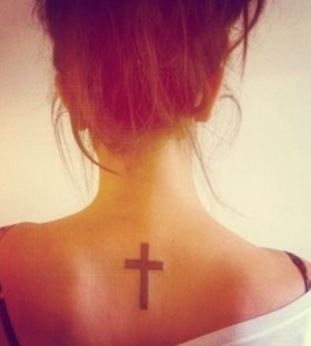 Small and pretty back cross tattoo