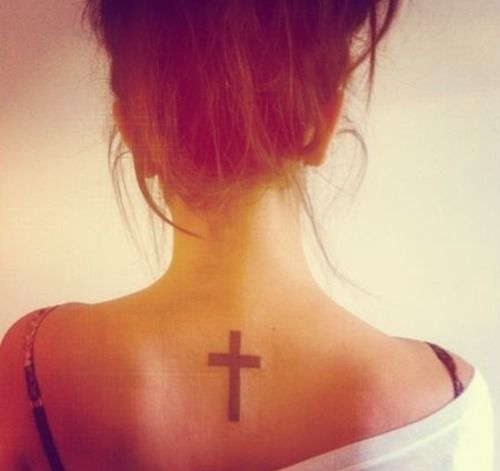 Small and pretty back cross tattoo