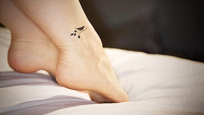 Small black bird tattoo