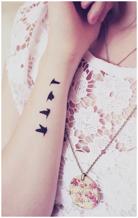 Small black birds tattoo on arm