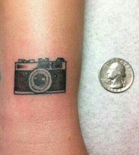 Small simple camera tattoo on arm