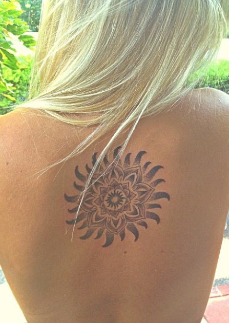 Smiling lovely back sun tattoo