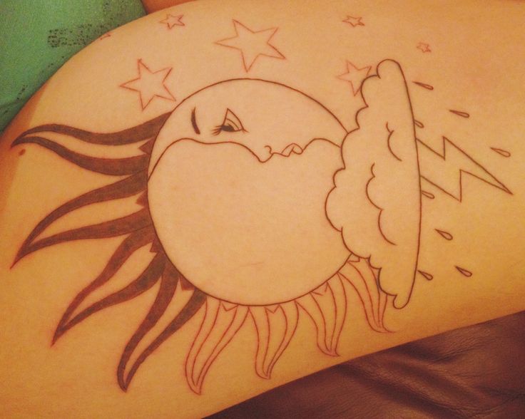 Star, moon and sun tattoo on leg