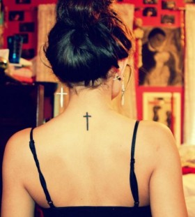 Traditional girl's back cross tattoo