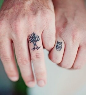 Tree and owl tattoo on finger