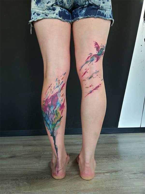 Watercolor tree and bird tattoo on leg