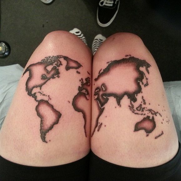 White and black map tattoo on legs