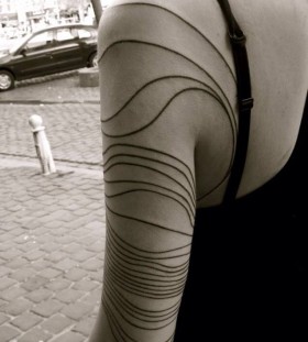Women's black line tattoo on arm