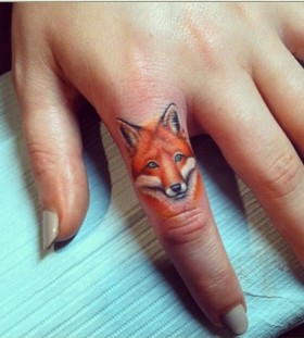 Yellow fox tattoo on finger