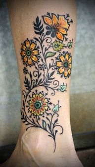 Yellow sunflowers flowers tattoo on leg