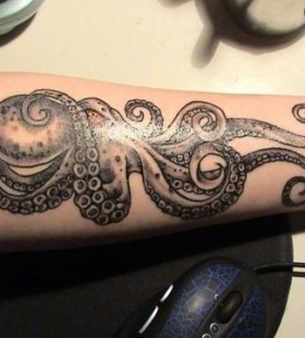 Adorable blue octopus tattoo on arm