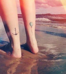 Black anchor, blue balloon tattoo