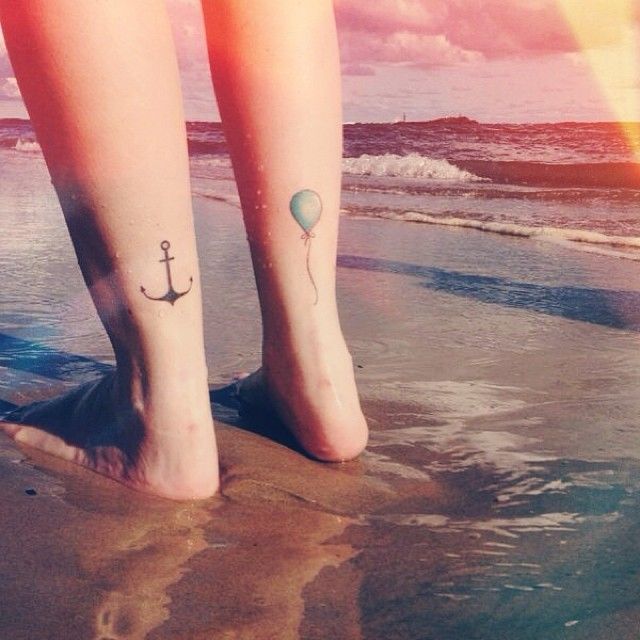 Black anchor, blue balloon tattoo