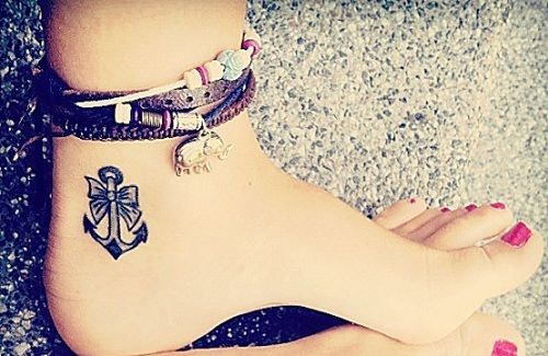 Black anchor girl tattoo on foot