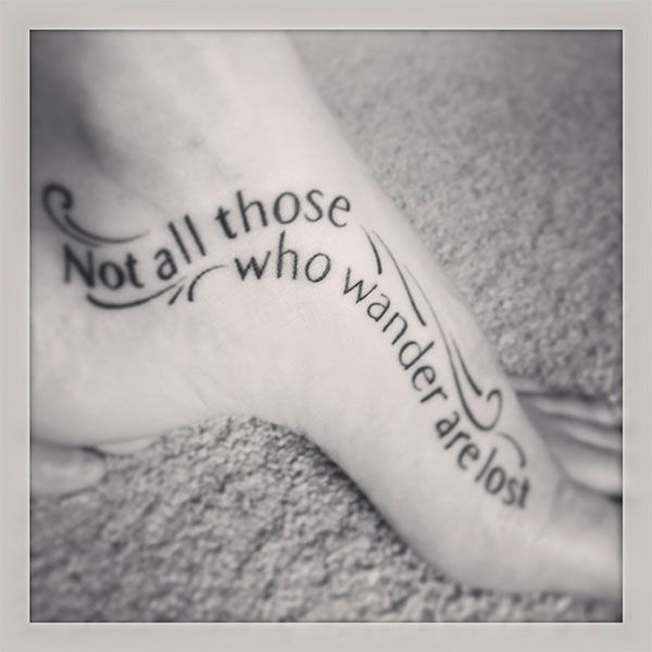 Black quote girl tattoo on foot