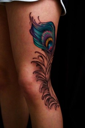 Blue and black peacock tattoo on leg