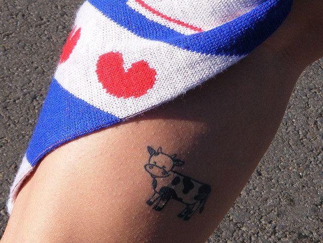 Blue and white cow tattoo