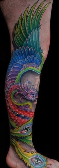 Blue, red, green peacock tattoo on leg