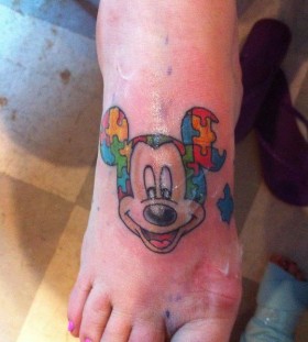 Colorful puzzles Mickey Mouse tattoo on arm