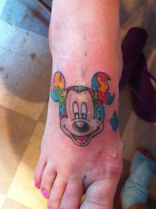 Colorful puzzles Mickey Mouse tattoo on arm