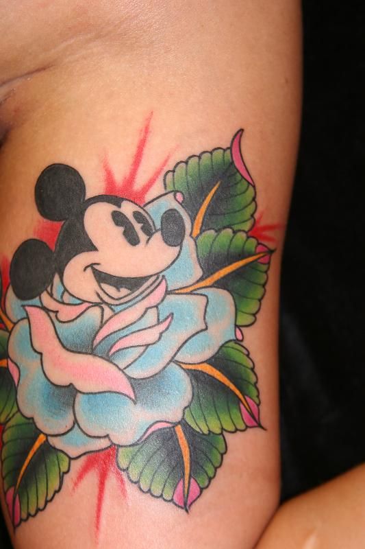 Green leafs and Mickey Mouse tattoo on leg