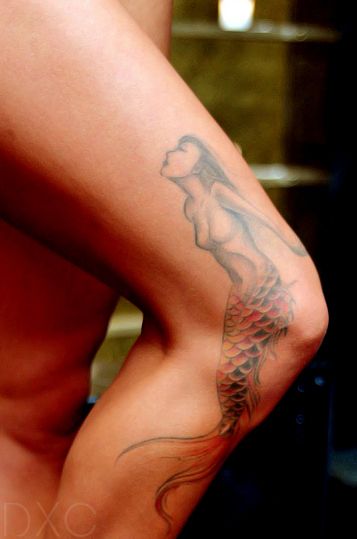 Knee’s red and black mermaid tattoo