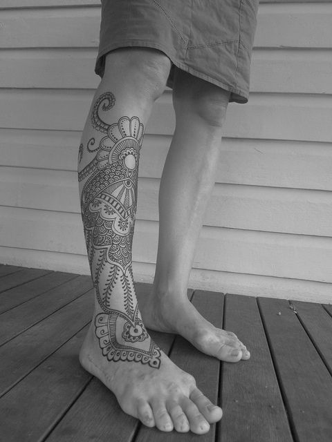 Lace and black octopus tattoo on leg