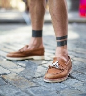 Lovely shoes and black men's geometric tattoo on leg