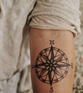 North and south compass tattoo on arm