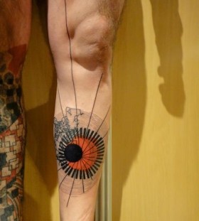Orange and black geometric tattoo on leg
