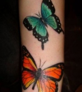 Orange and green butterfly tattoo