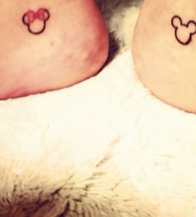 Pretty red bow with Mickey Mouse tattoo on leg