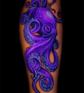 Purple black octopus tattoo on arm