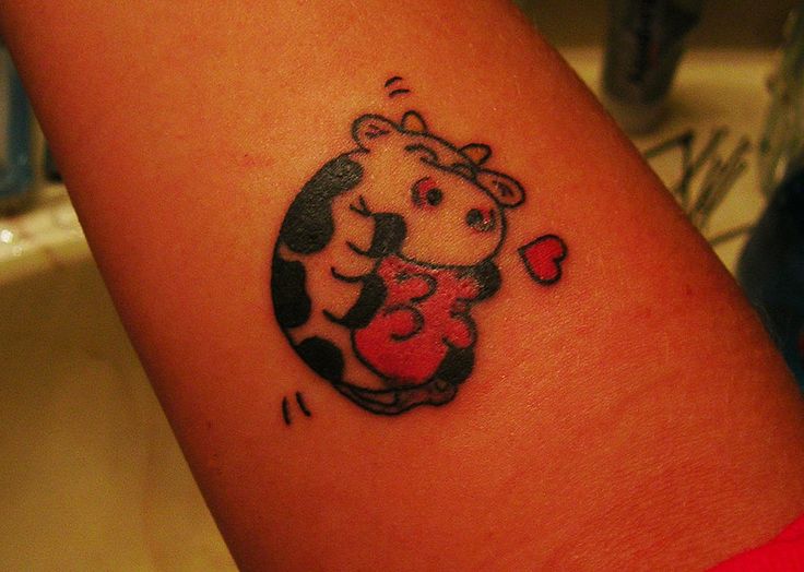 Red heart and cow tattoo