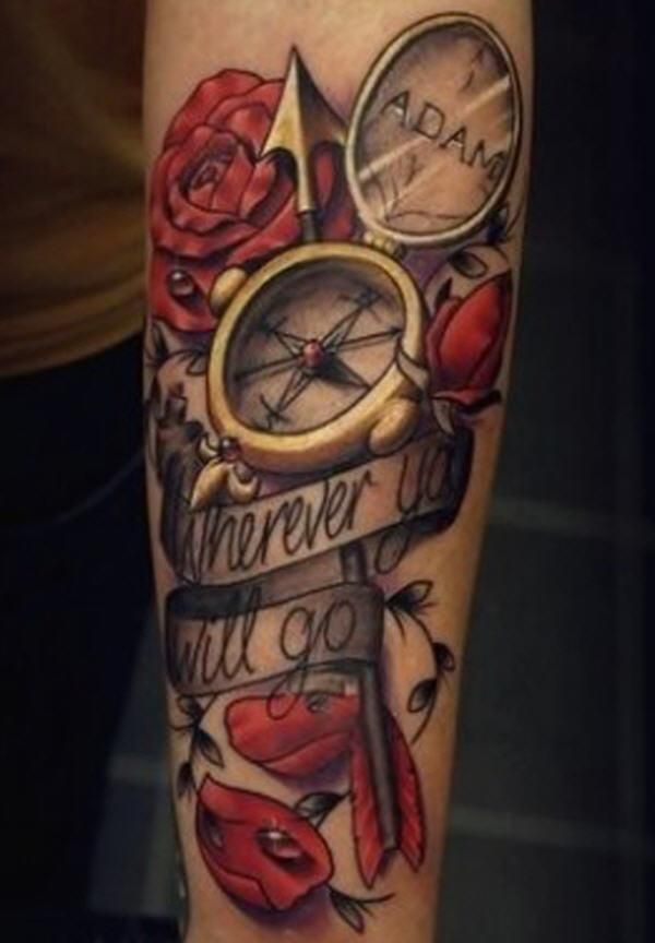 Red roses and lovely compass tattoo on arm