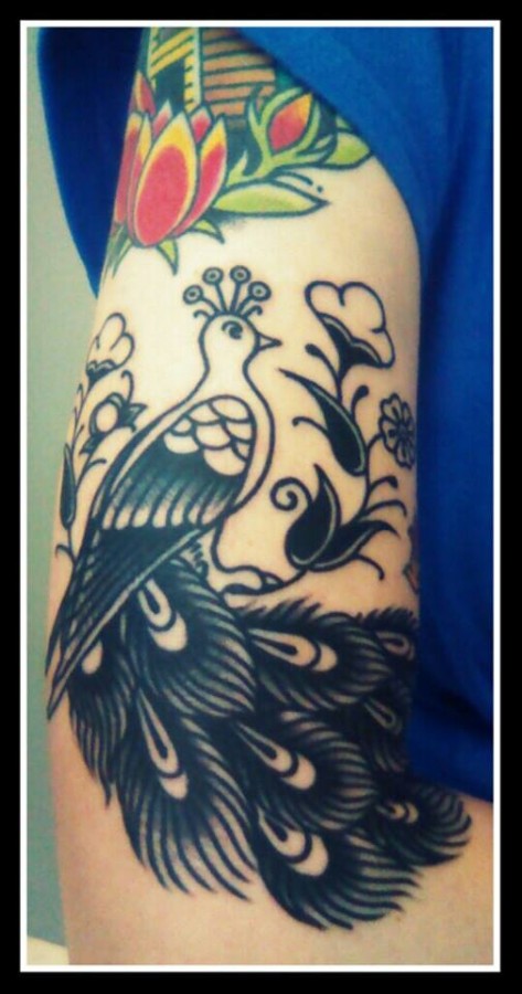 Red tulips and black peacock tattoo on leg