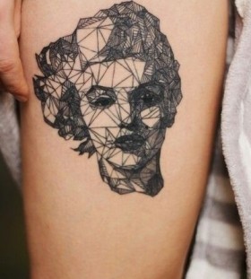 Women's face geometric tattoo on leg