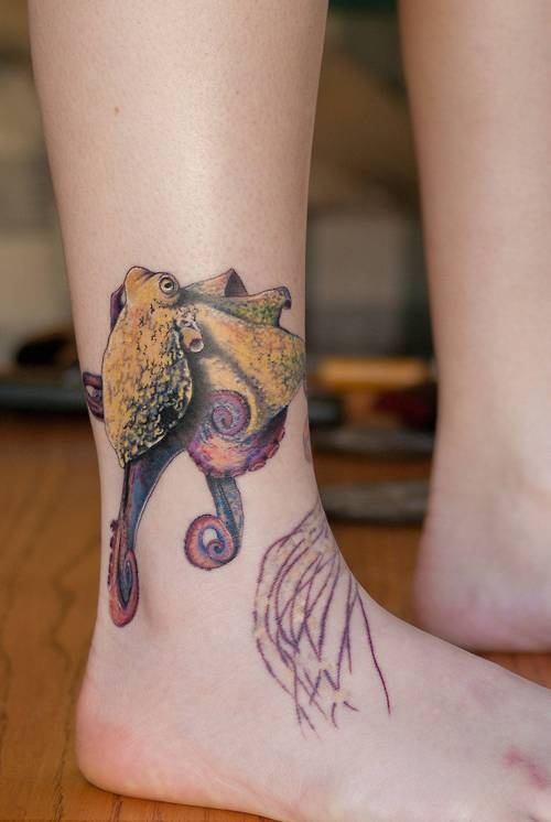 Yello, purple octopus tattoo on leg