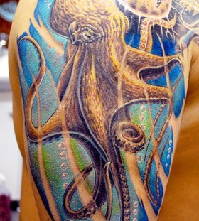 Yellow and blue octopus tattoo on arm