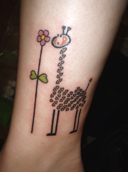 giraffe with flower tattoo on ankle