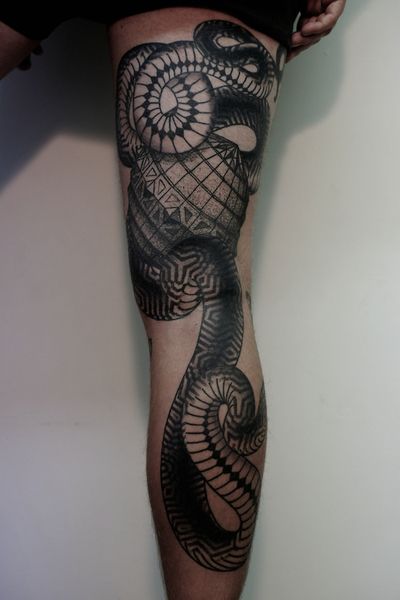 large snake tattoo on leg