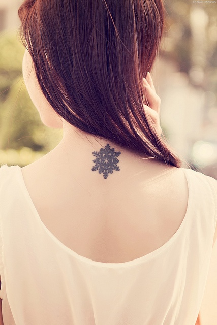 simple snowflake tattoo on neck